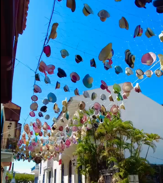 Decoración aérea de sombreros coloridos colgando sobre una calle colonial en Panamá Decoración aérea de sombreros coloridos colgando sobre una calle colonial en Panamá